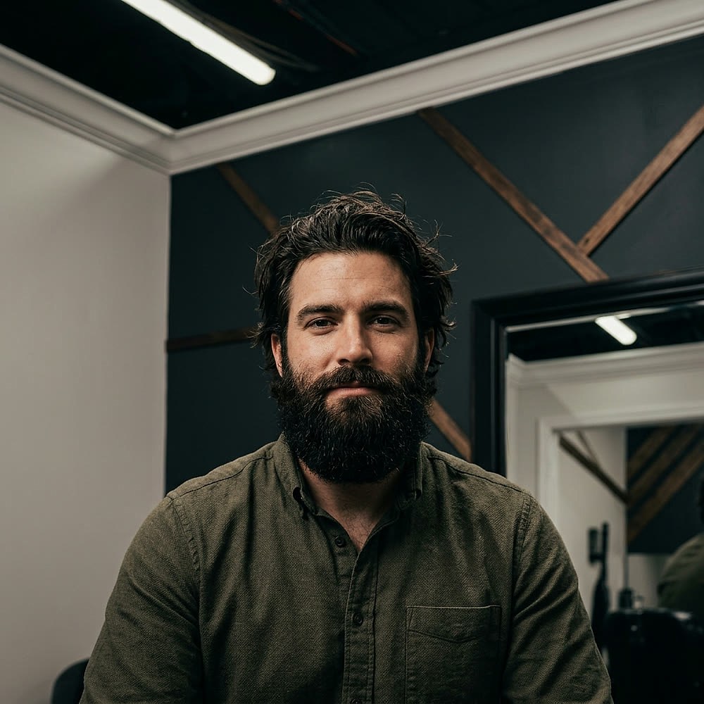 Before — long hair and full beard in Drew's shop